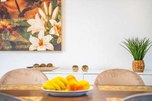 a dining room table with a plate of fruit on it at Lighthouse view- POOL VILLA in Porto Moniz