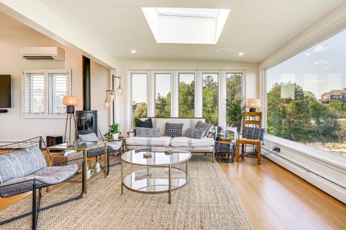 a living room with furniture and a large window at Elegant Gloucester Beach Getaway with Ocean Views! in Gloucester
