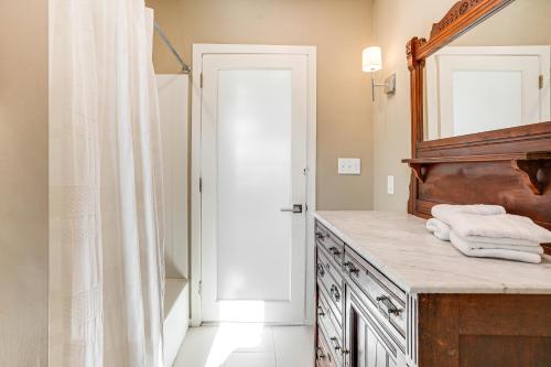 a bathroom with a mirror and a sink with towels at Elegant Gloucester Beach Getaway with Ocean Views! in Gloucester