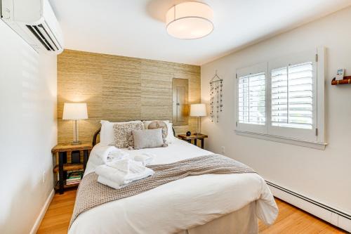 a bedroom with a large bed and a window at Elegant Gloucester Beach Getaway with Ocean Views! in Gloucester