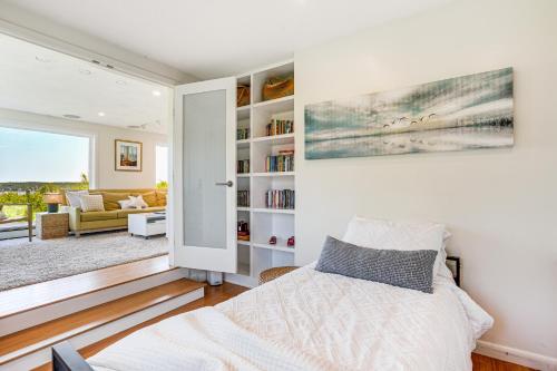 a bedroom with a bed and a living room at Elegant Gloucester Beach Getaway with Ocean Views! in Gloucester