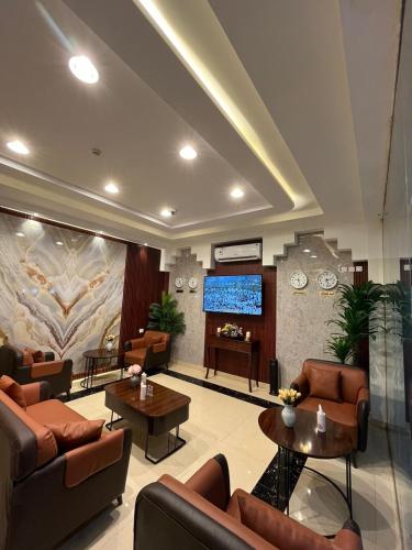 a lobby with couches and a flat screen tv at إطلالة السيب للشقق المخدومة Itlalat Alseeb Serviced Apartments in Al Khafji