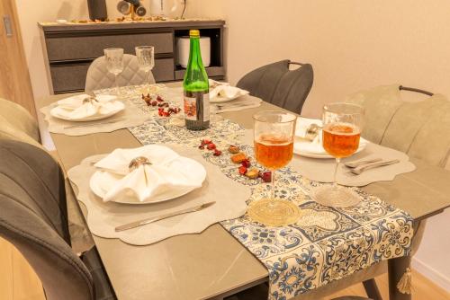 a table with a bottle of wine and glasses on it at 金柑小屋 in Osaka