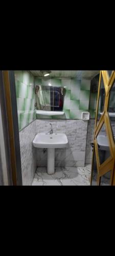a bathroom with a white sink and a mirror at شقق Hs 4 in Cairo