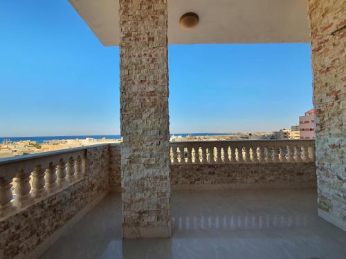 a view from the balcony of a building with columns at بيت العز للشقق الفندقية - علم الروم Bet Elezz Apartments-Alam Elrom in Marsa Matruh