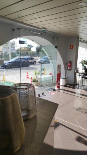 a lobby with a view of a parking lot at Hotel Alnacir in Faro