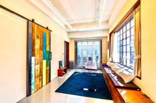 a living room with a couch and a large window at Yeongjingil 51 in Gangneung