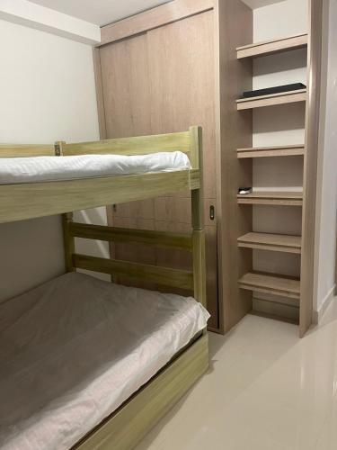 a room with two bunk beds and a closet at peña azul la morada Sánchez in Ricaurte