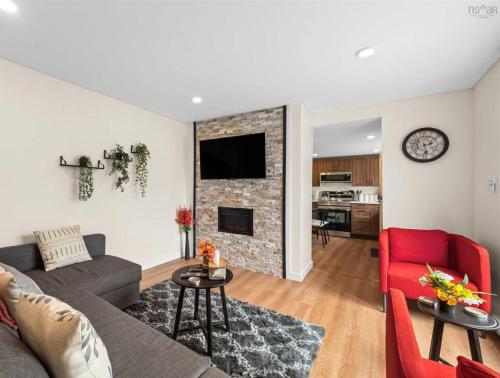 a living room with a couch and a fireplace at Serenity Getaway in Halifax