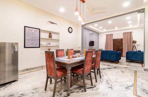 a dining room with a table and chairs at Stylish & Cozy Retreat with Jacuzzi in Jaipur
