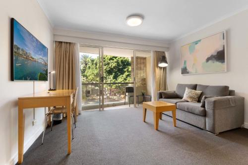 a living room with a couch and a table at Marvelous Manly in Sydney