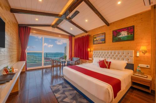 a bedroom with a bed and a table and a window at Hotel Wood Stock Luxury - A Boutique Property - Penthouse - Open Air Restaurant & Terrace in Kasauli