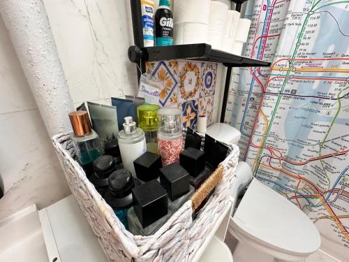 a basket with cosmetics and other items in a bathroom at King size room with shared bathroom in New York