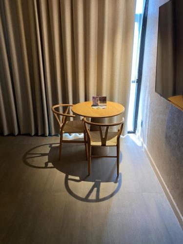a table and chair in a room with a window at Motel London in Guadalajara