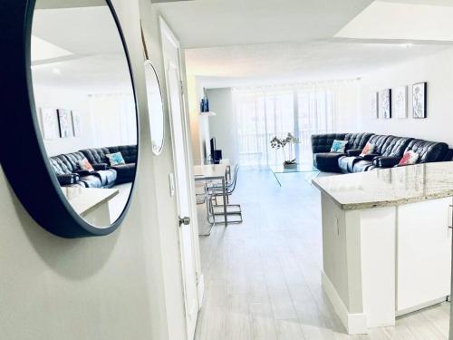 a living room with a mirror and a couch at MODERN 2BR 2BA CONDO near AVENTURA! Wi-Fi! Parking in North Miami Beach