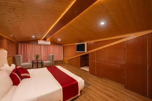 a hotel room with a bed and a tv at Hotel Wood Stock Luxury - A Boutique Property - Penthouse - Open Air Restaurant & Terrace in Kasauli