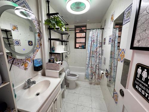 a bathroom with a sink and a toilet and a shower at queen size room with shared bathroom in New York