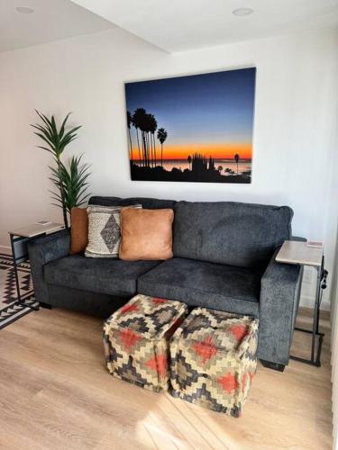 a living room with a couch and a painting on the wall at Carpinteria Beach Studio Condo in Carpinteria