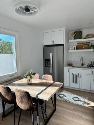 a kitchen with a table with chairs and a refrigerator at Carpinteria Beach Studio Condo in Carpinteria
