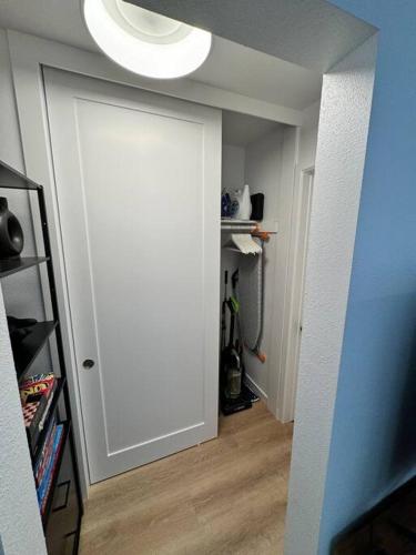 a white door with a light on top of it at Carpinteria Beach Studio Condo in Carpinteria