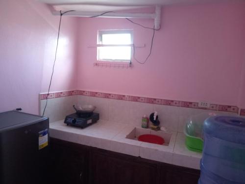 a kitchen with a sink and a window at Kelsey's Homestay in Burgos