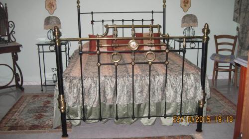 a bedroom with a bed with a metal frame at Merzuq House in Birżebbuġa