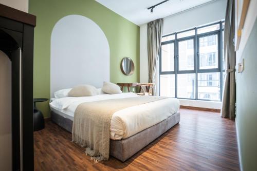 a bedroom with a bed and a large window at K Avenue by Pinstay in Donggongon