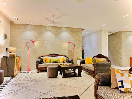a living room with two couches and a table at Divine Inn Hotel Near Rajouri Garden Main Market in New Delhi