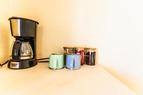 a row of coffee cups sitting on a counter at Atenea Holbox in Holbox Island