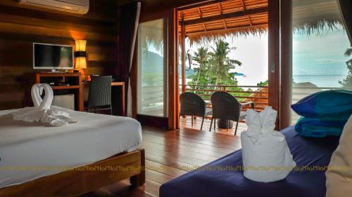 a bedroom with a bed and a view of the ocean at Ten Moons Lipe Resort in Ko Lipe