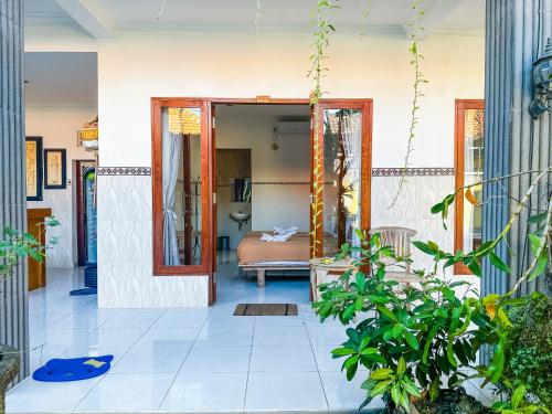 a living room with a bed in a room at Sanata Yoga Guesthouse in Canggu