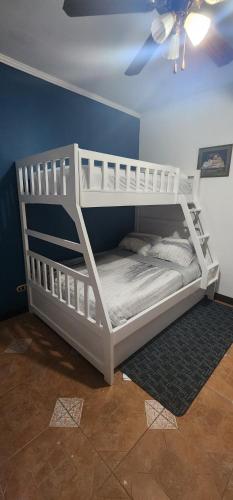 a white bunk bed in a room with a ceiling at CASA DE PLAYA CON PISCINA EN PUNTA LEONA in Puntarenas