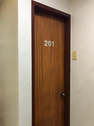 a wooden door with the number on it at Prime Location, Spacious & Modern 4BR City Townhouse in Cagayan de Oro