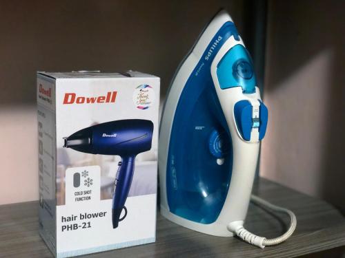 a blue and white hair dryer next to a box at Prime Location, Spacious & Modern 4BR City Townhouse in Cagayan de Oro