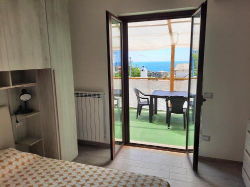 a bedroom with a table and chairs on a balcony at Appartamenti Miramare in Marina di Camerota