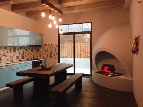 a kitchen with a wooden table with a bench in it at 精彩奇寓站前電梯主題民宿走路到車站好停車 in Hualien City