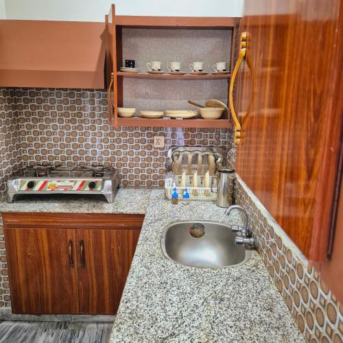 a kitchen with a sink and a counter top at Roof Top Resort in Murree
