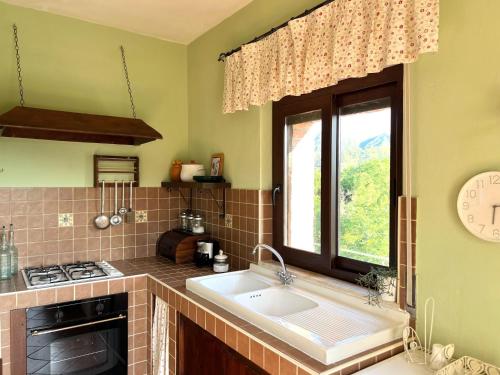 a kitchen with a sink and a stove and a window at Holiday home, Francavilla di Sicilia in Francavilla di Sicilia