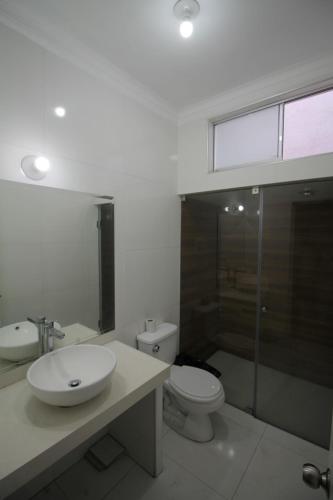 a bathroom with a sink and a toilet at Casa Águila y Cóndor in Lima