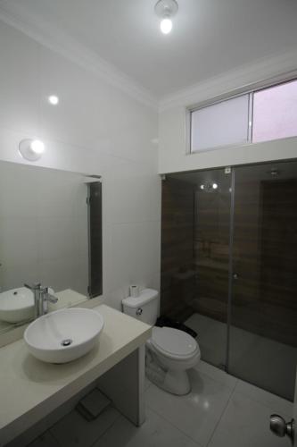 a bathroom with a sink and a toilet at CASA ÁGUILA y CÓNDOR in Lima