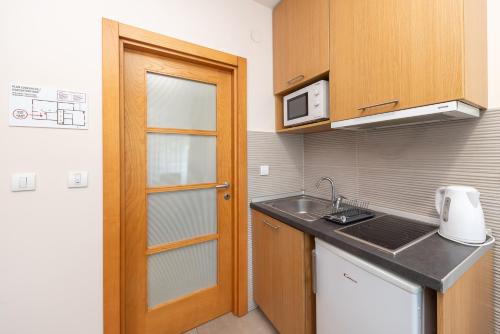 a small kitchen with a sink and a microwave at Top Central Apartments in Belgrade