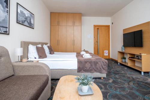 a hotel room with a bed and a couch at Top Central Apartments in Belgrade