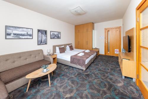 a hotel room with a bed and a couch at Top Central Apartments in Belgrade