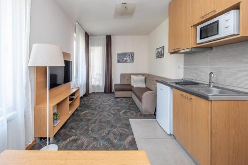 a room with a kitchen and a living room at Top Central Apartments in Belgrade