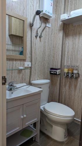 a bathroom with a toilet and a sink at 和光寓所-自助加Line取密碼 in Hung-i-li