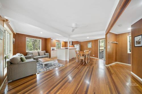 a living room with a couch and a table at A Turtle House by Discover Stradbroke in Point Lookout