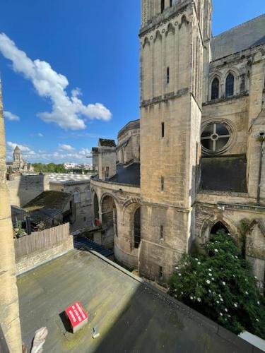 un vieux bâtiment avec un objet rouge sur le toit dans l'établissement Studio au coeur du centre historique, vue unique, à Caen