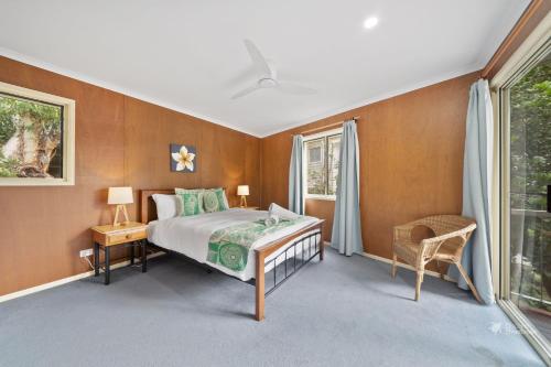 a bedroom with a bed and a window at A Turtle House by Discover Stradbroke in Point Lookout