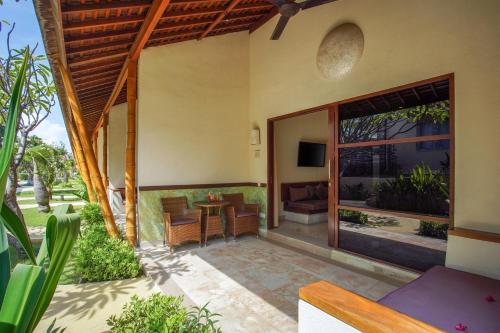a patio of a house with a table and chairs at Pearl of Trawangan in Gili Trawangan