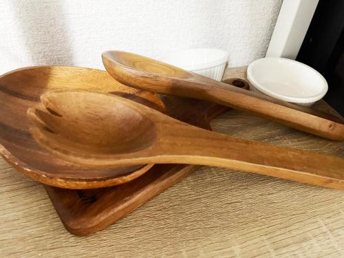 two wooden spoons sitting on top of a table at Feliz Kumamoto in Kumamoto